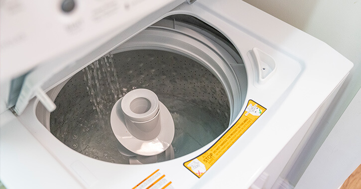 mr. appliance professional working on washing machine