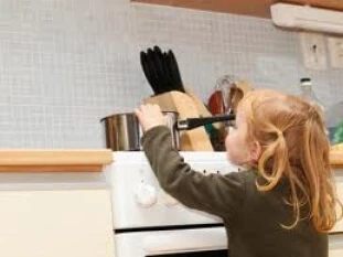 Child reaching for a hot pot Child reaching for a hot pot